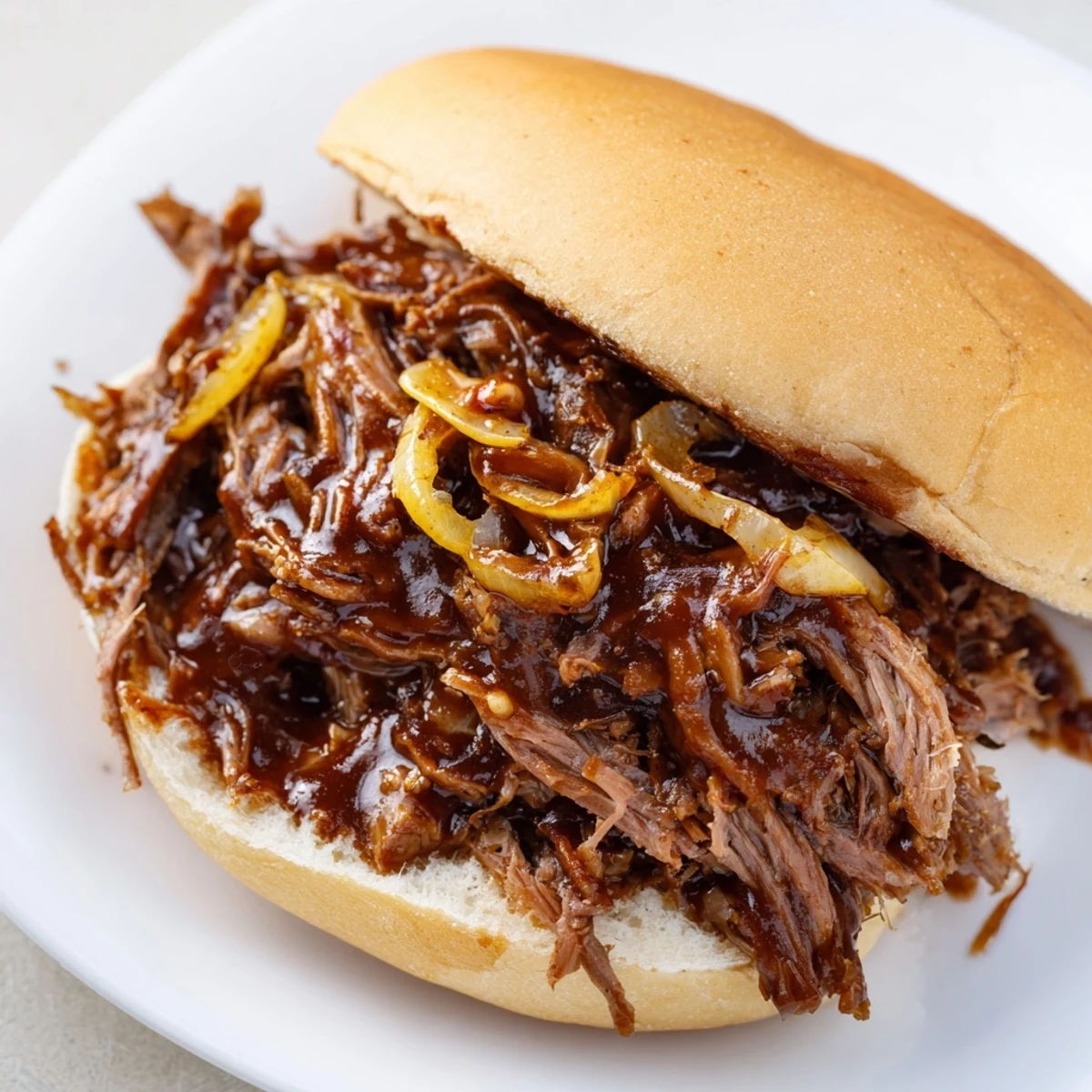 Tender Slow Cooker Pulled Beef Sandwiches served with coleslaw and pickles, perfect for a comforting dinner or game day gathering.