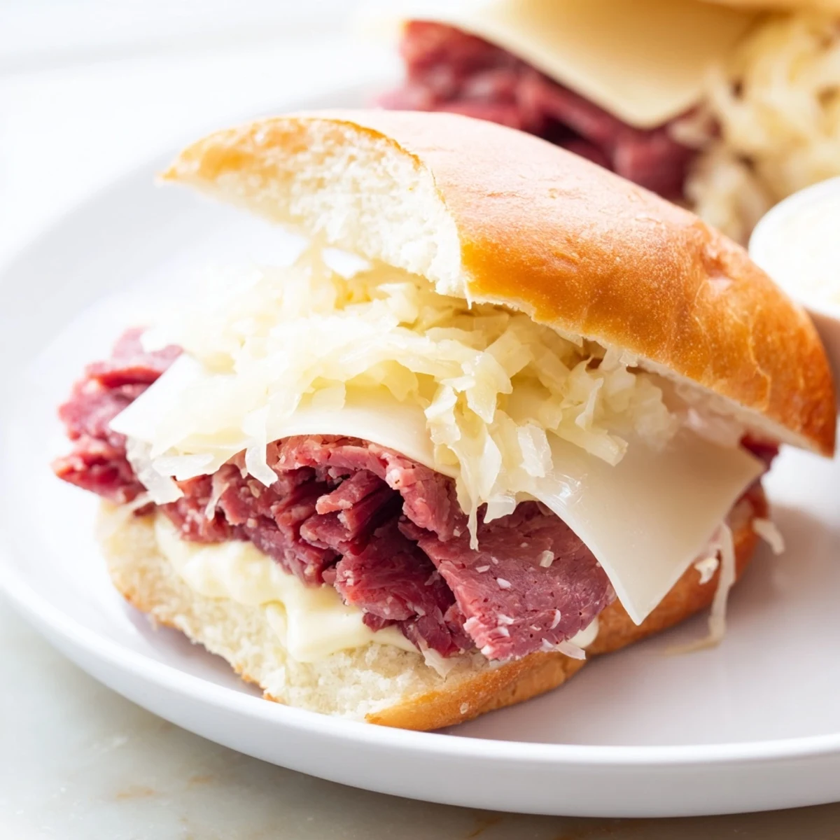 Hot Corned Beef Sliders with Stone Ground Mustard served warm, featuring shredded cabbage and soft brioche buns.