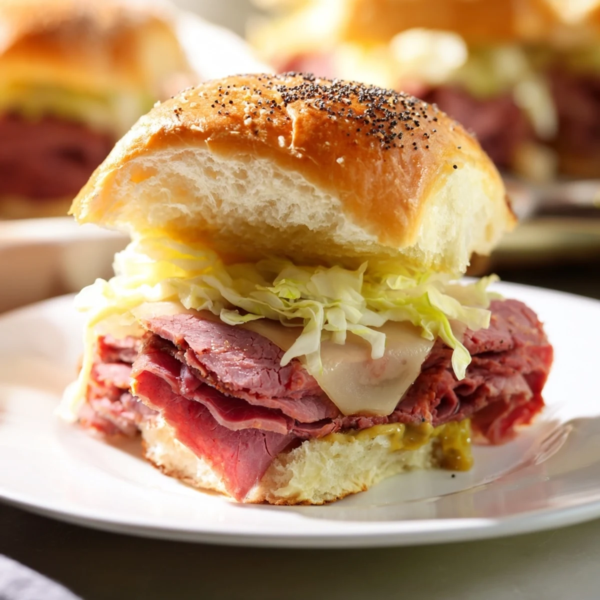 Savory Corned Beef Sliders with Stone Ground Mustard feature melted Swiss cheese and tangy mustard on golden toasted buns.