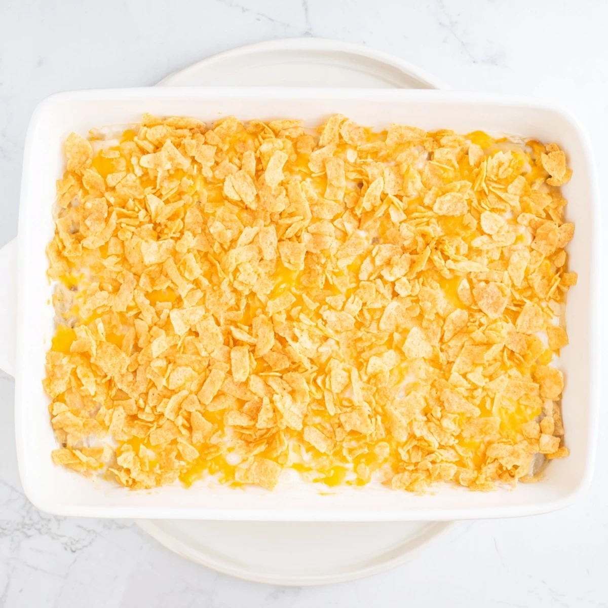 A close-up of Funeral Potatoes with Hashbrowns, showing tender shredded potatoes and a golden, crisp topping.