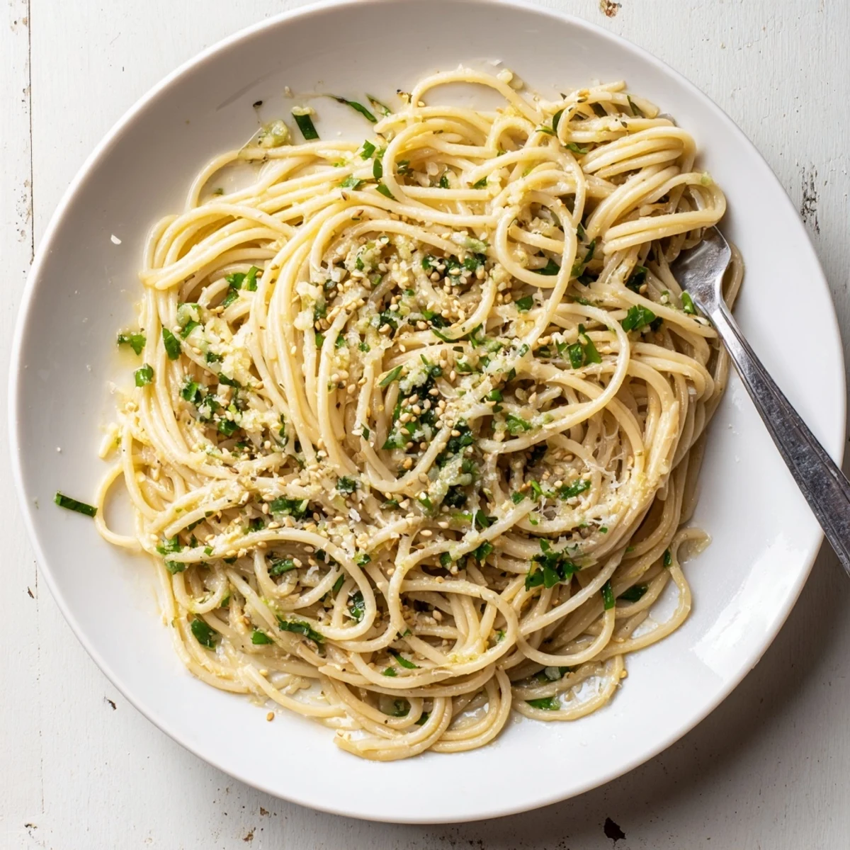 Sizzling skillet of garlic noodles with aromatic garlic and soy glaze, served warm and inviting.
