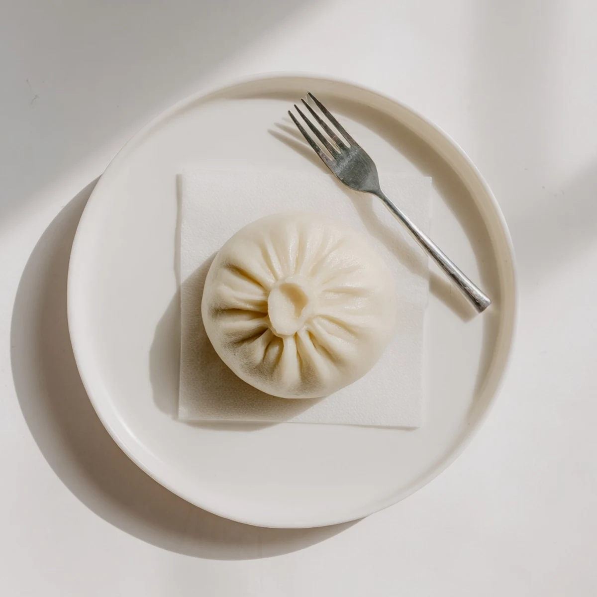 Fluffy Vietnamese Banh Bao steamed bun filled with savory pork and mushrooms.