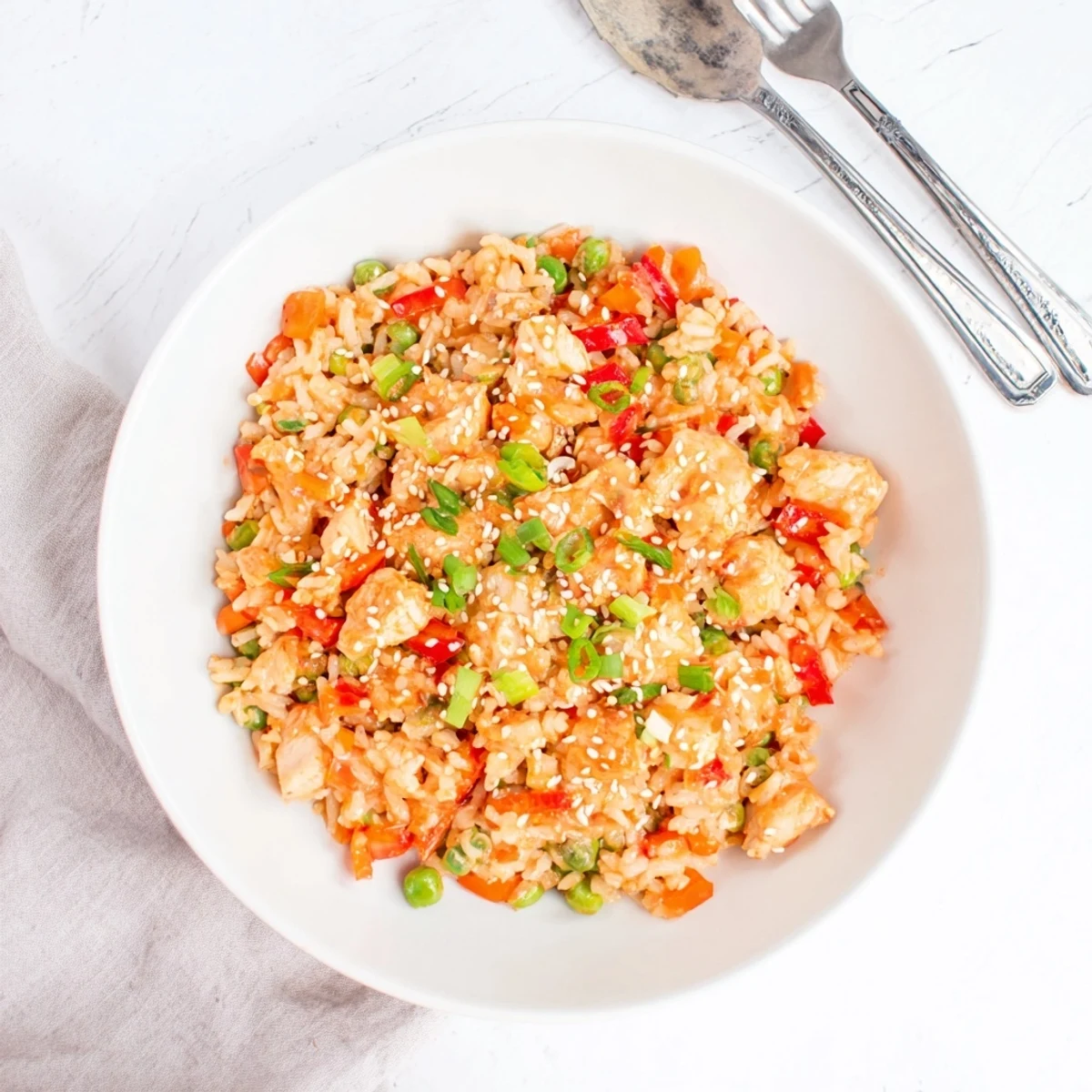 Golden fried rice tossed with crispy chicken, peas, carrots, and bell peppers, drizzled with creamy Bang Bang sauce.