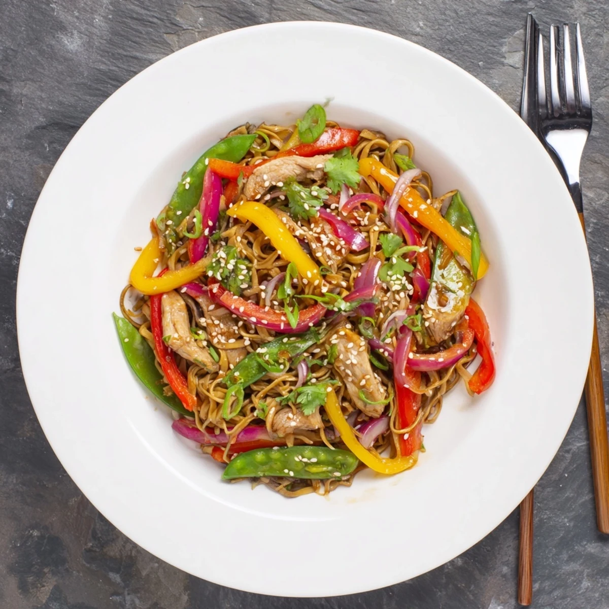 Vibrant Sweet Chilli Turkey Noodle Stir Fry with tender turkey and crisp red bell peppers on a plate.