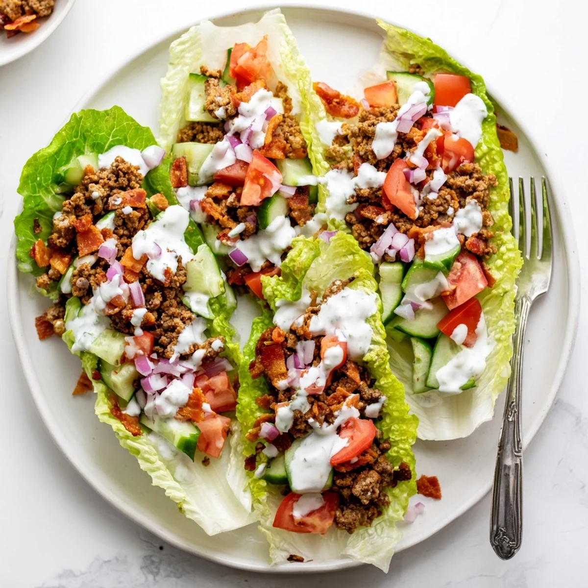 Golden brown meat and crumbled bacon nestled in crisp butter lettuce leaves with tangy ranch glaze