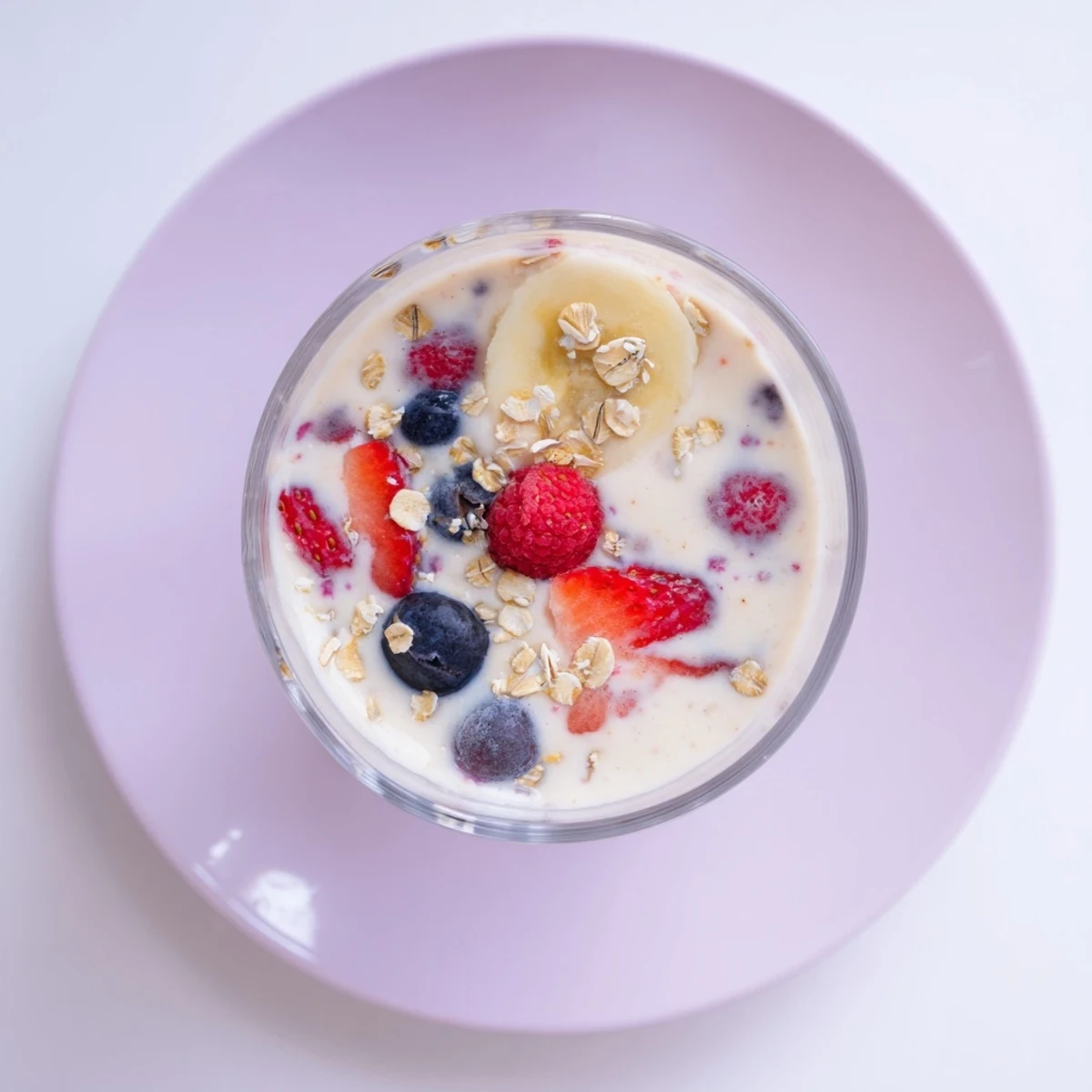 Thick creamy Greek yogurt breakfast smoothie blended with mixed berries and banana in a glass