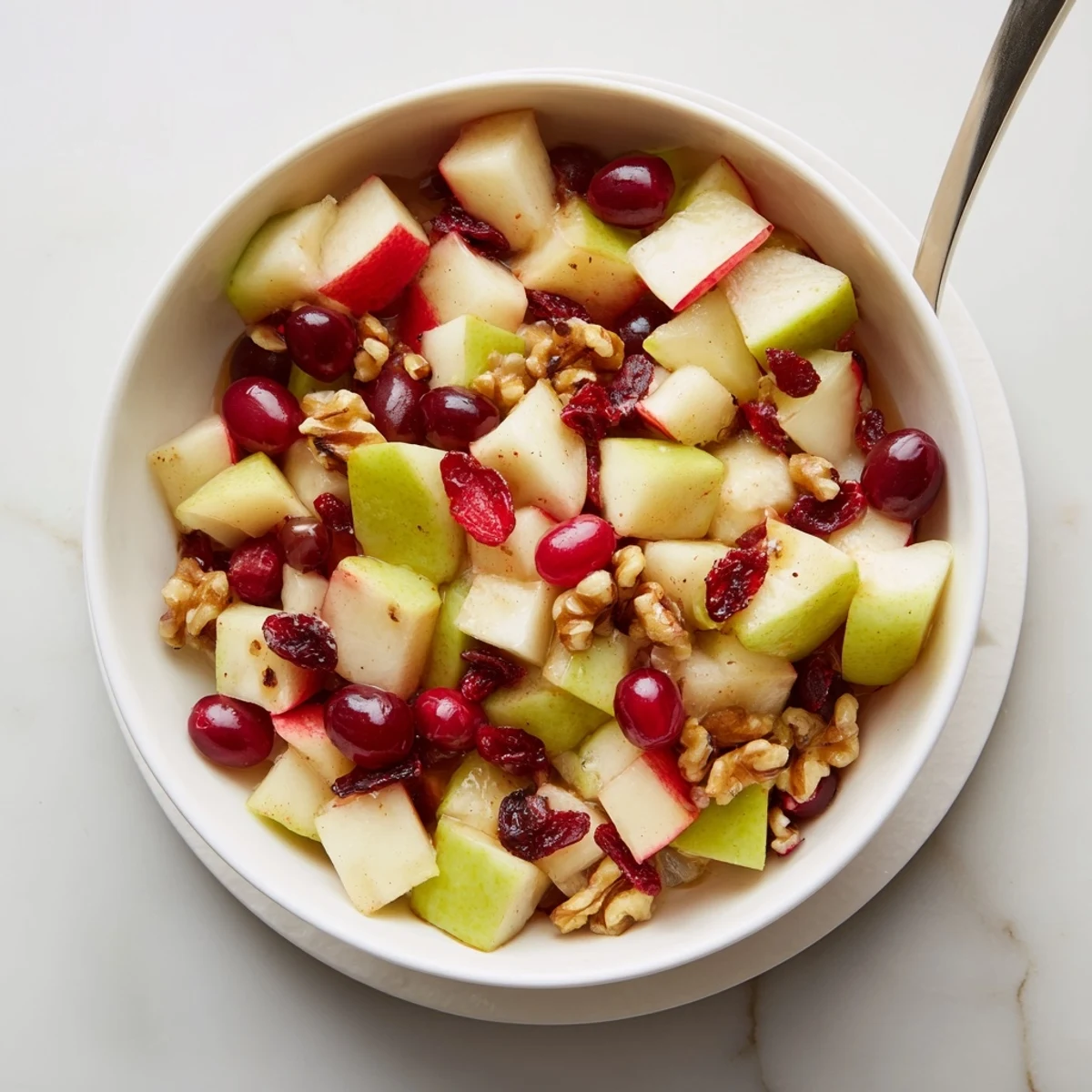 Fresh chopped apples, grapes, and cranberries coated in sweet citrus dressing for a healthy fall treat