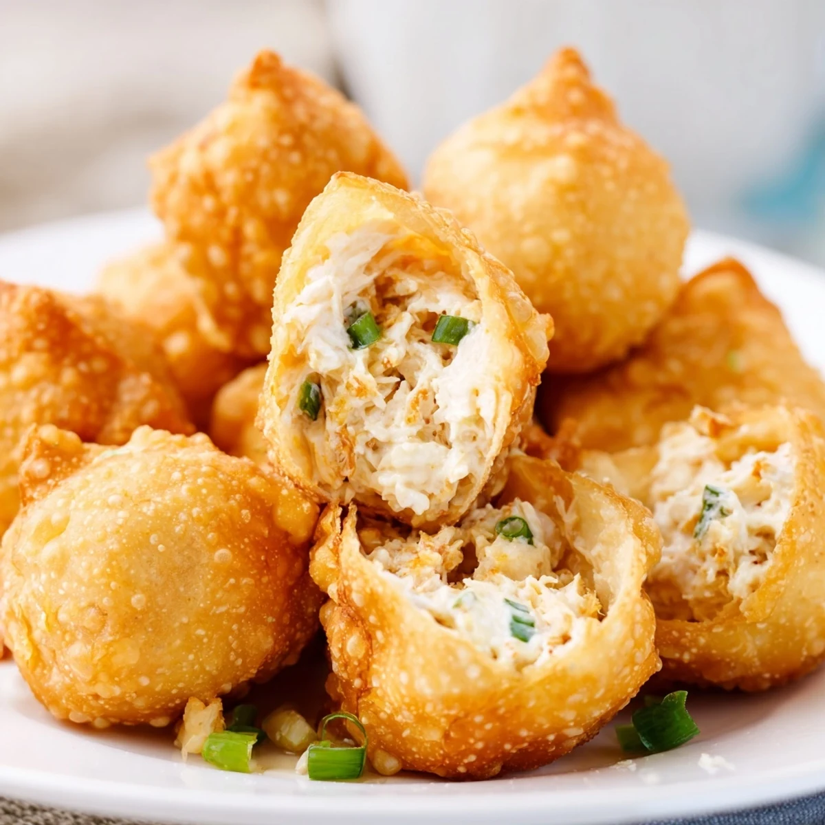 Close-up of golden Crab Rangoon Bombs showing creamy crab cheese filling inside crispy wrapper