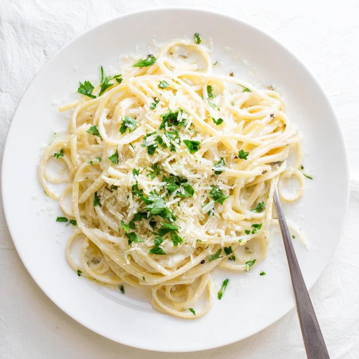 Golden parmesan cheese coats tender spaghetti noodles in this creamy garlic butter pasta dish