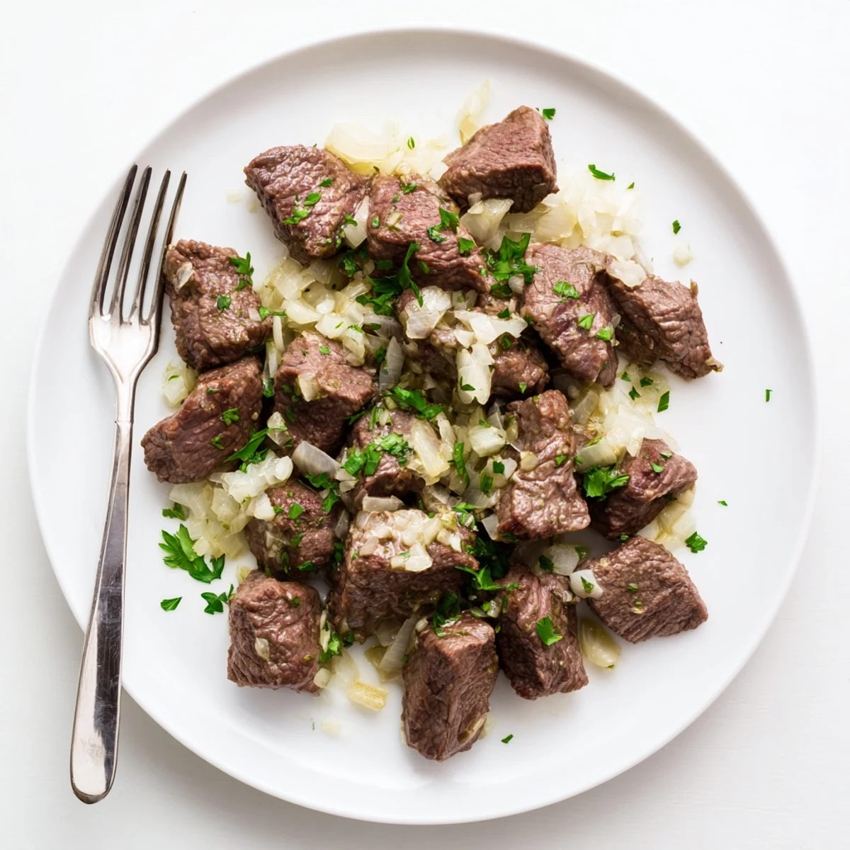 Juicy slow cooker steak bites simmered with herbs and served over fluffy mashed potatoes