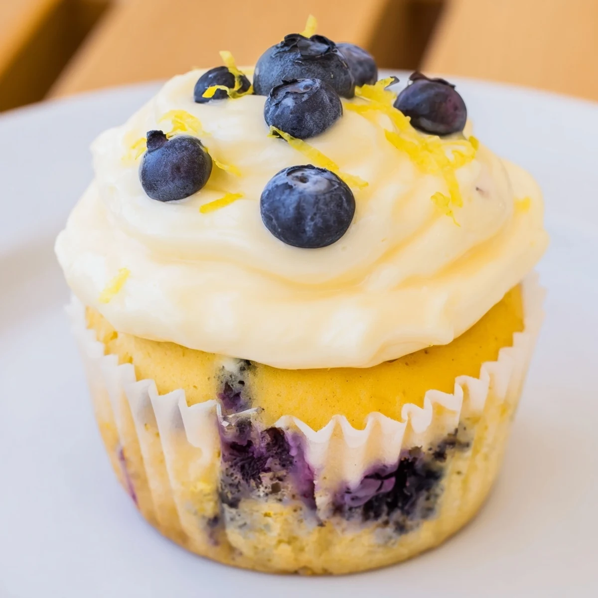 Light and moist lemon blueberry cupcakes with swirls of lemon cream cheese frosting and summer berries