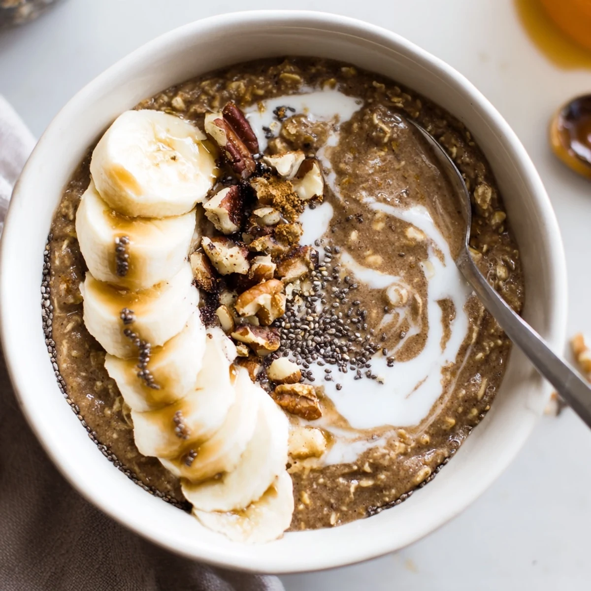 Creamy Brown Sugar Coffee Overnight Oats topped with sliced banana and toasted pecans.