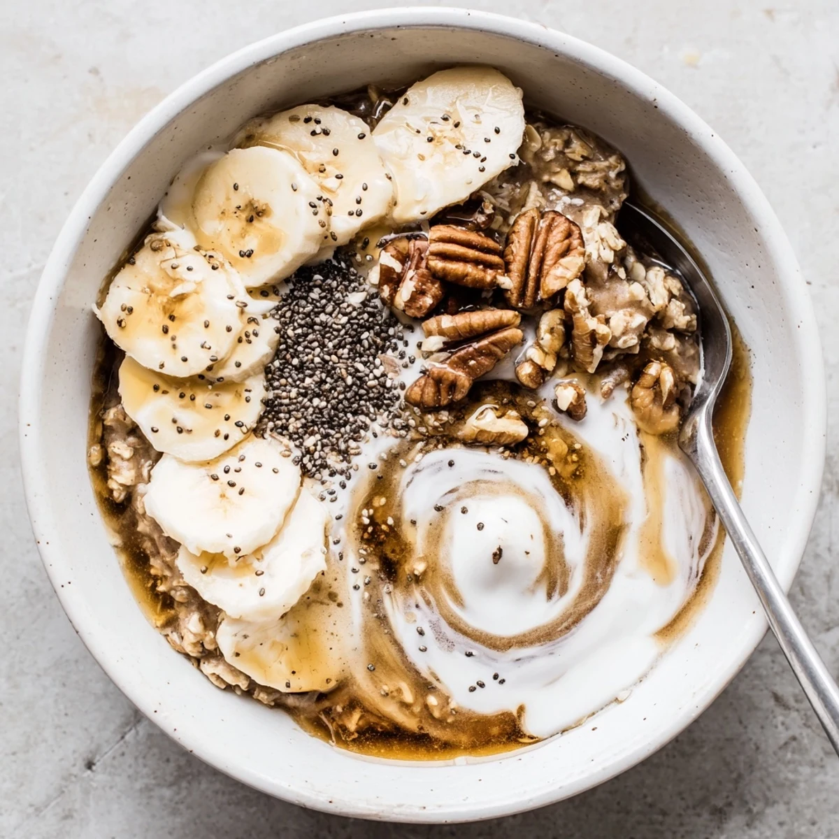 Velvety Brown Sugar Coffee Overnight Oats spooned into bowls, garnished with maple drizzle.
