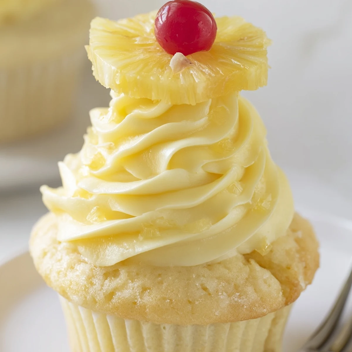 Freshly baked Dole Whip Cupcakes Recipe glistening with pineapple frosting, ready to serve