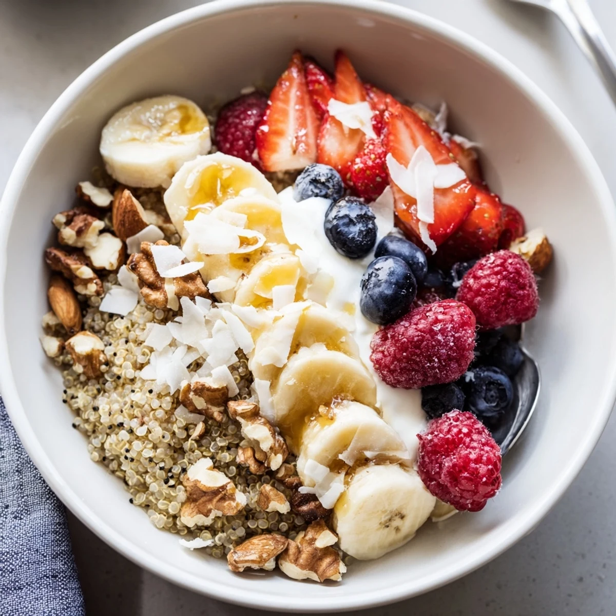 Quinoa Breakfast Bowl with fluffy quinoa, creamy yogurt, and fresh berries.