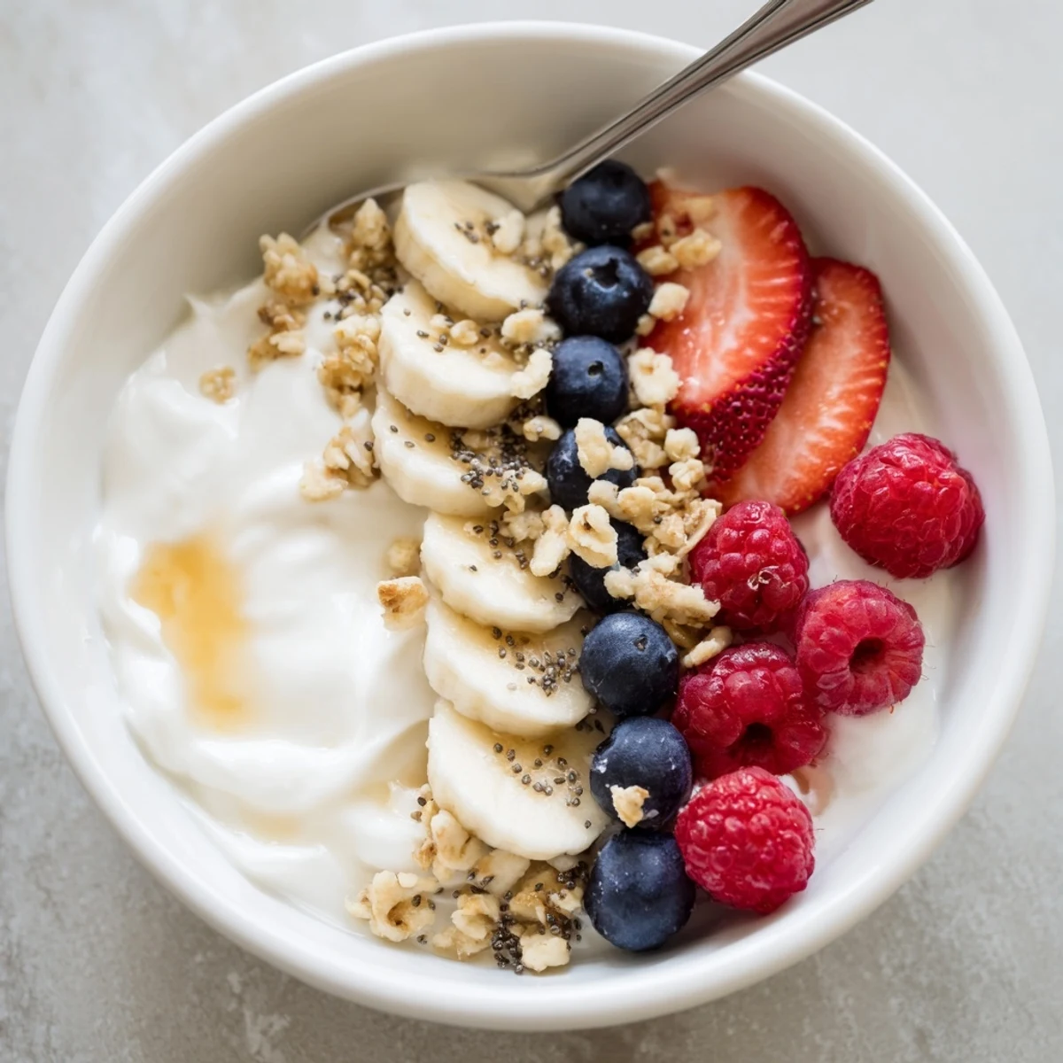 Cottage Cheese Breakfast Bowl topped with juicy berries, crunchy granola, honey drizzle.