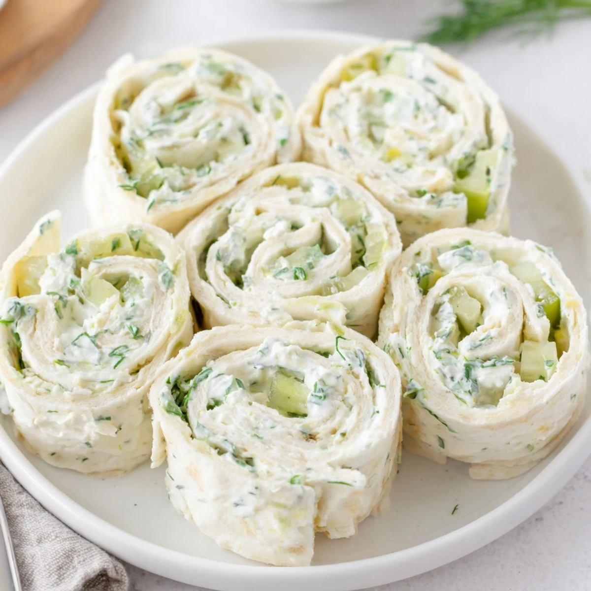 Pickle Dip Pinwheels arranged on platter, creamy dill filling served chilled  