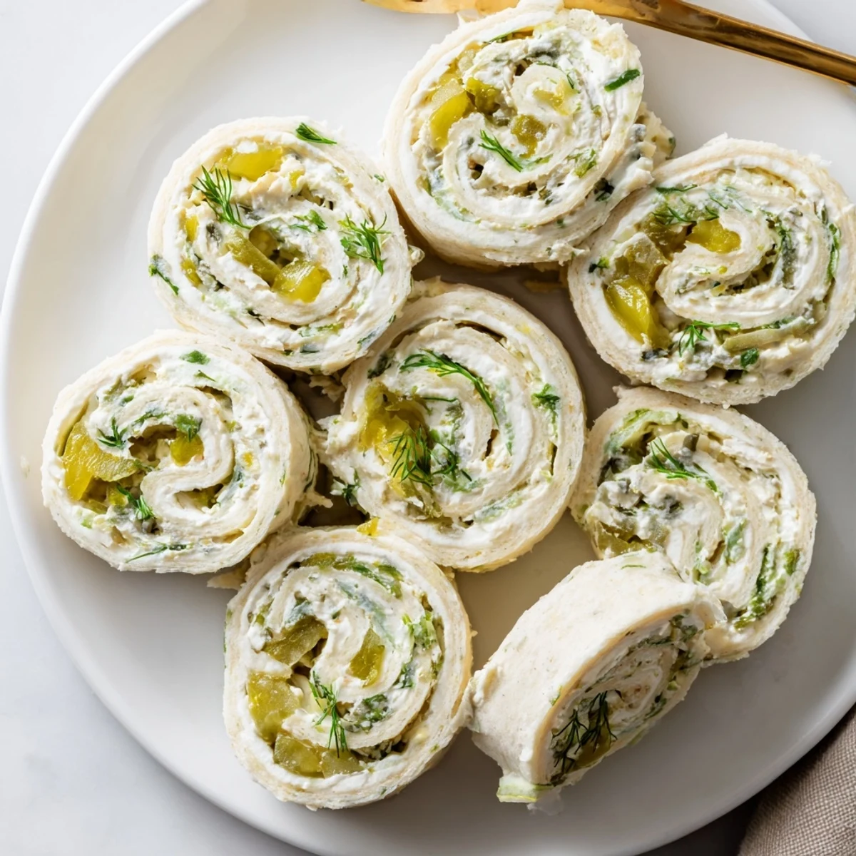 Close-up of Pickle Dip Pinwheels sliced evenly, tangy pickle bits visible  