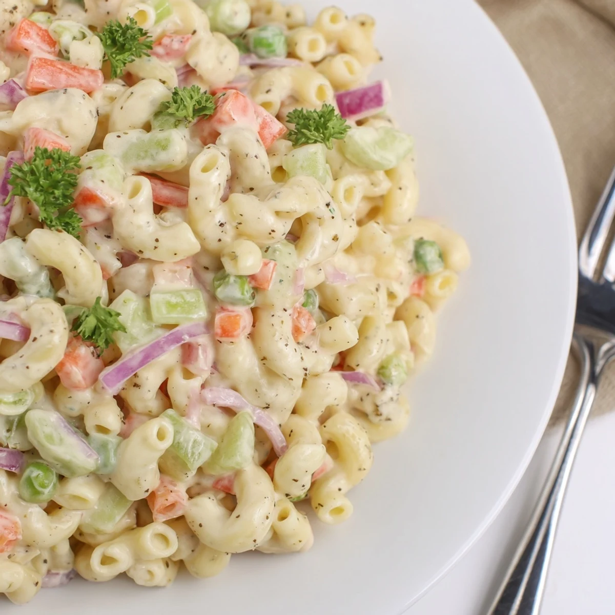 Classic picnic Macaroni Salad studded with peas, carrots, creamy dressing