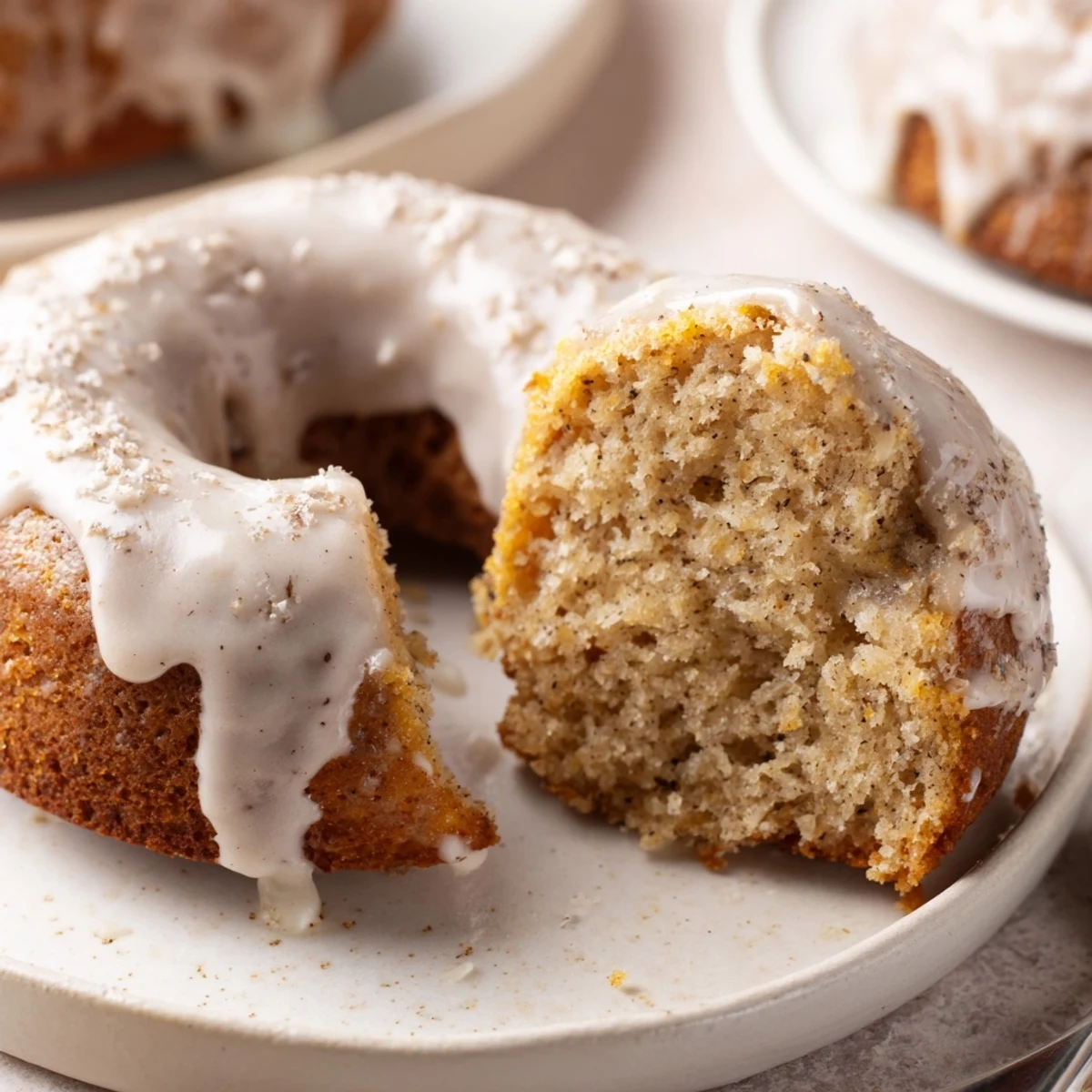 Fresh-baked Banana Donuts cooling on wire rack, ready for sweet glaze