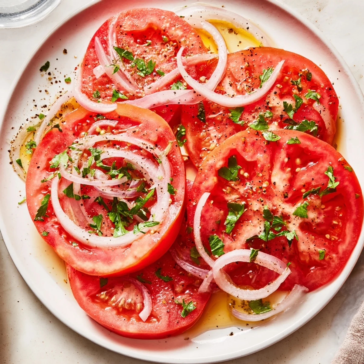 Tomato And Onion Salad glistening with vinaigrette, fragrant parsley, ready to serve