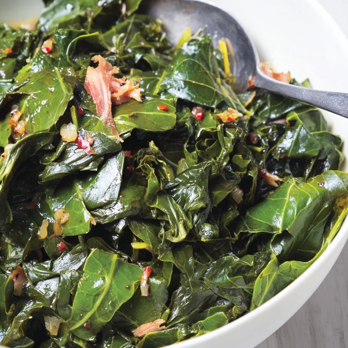 Homestyle Collard Greens glistening with olive oil, seasoned, served over rice