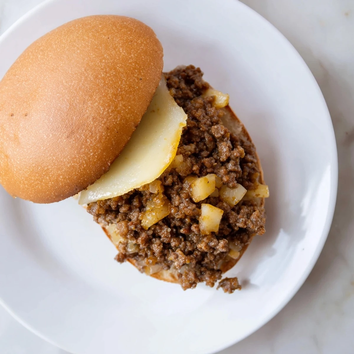 Mouthwatering ground beef simmered with sweet onions creates these irresistible French Onion Beef Sloppy Joses with gooey cheese