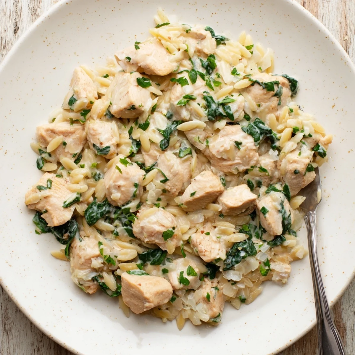 Creamy one pan Boursin chicken orzo with spinach served in a skillet