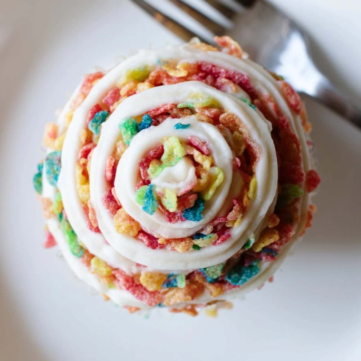 Bright Fruity Pebbles Cereal Frosting spread thick on chocolate cake, crunchy garnish