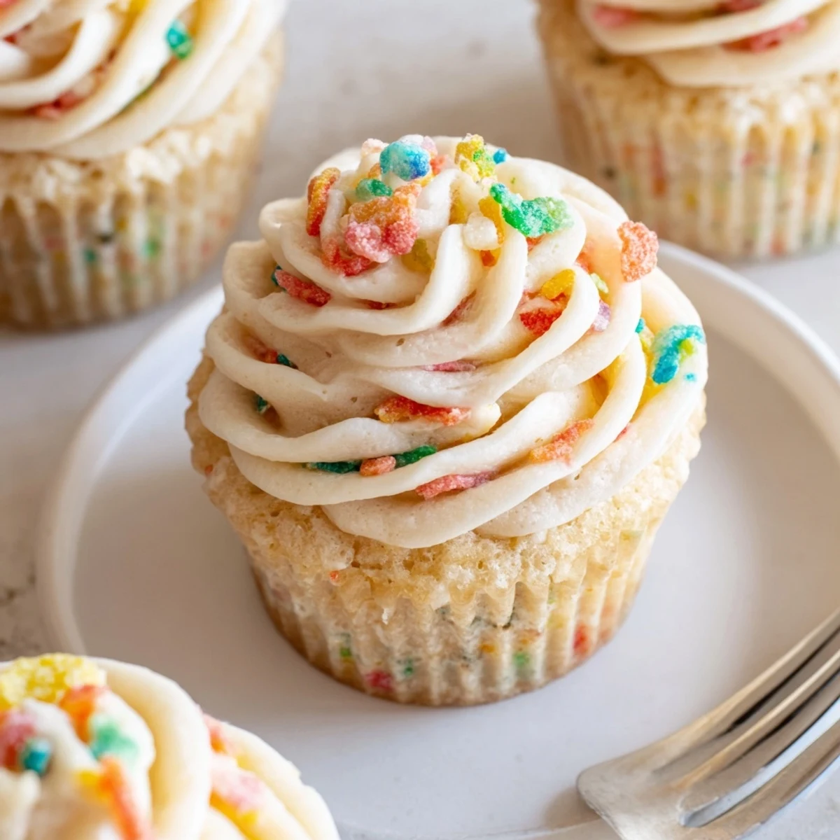 Velvety Fruity Pebbles Cereal Frosting in bowl, colorful cereal sprinkled for serving