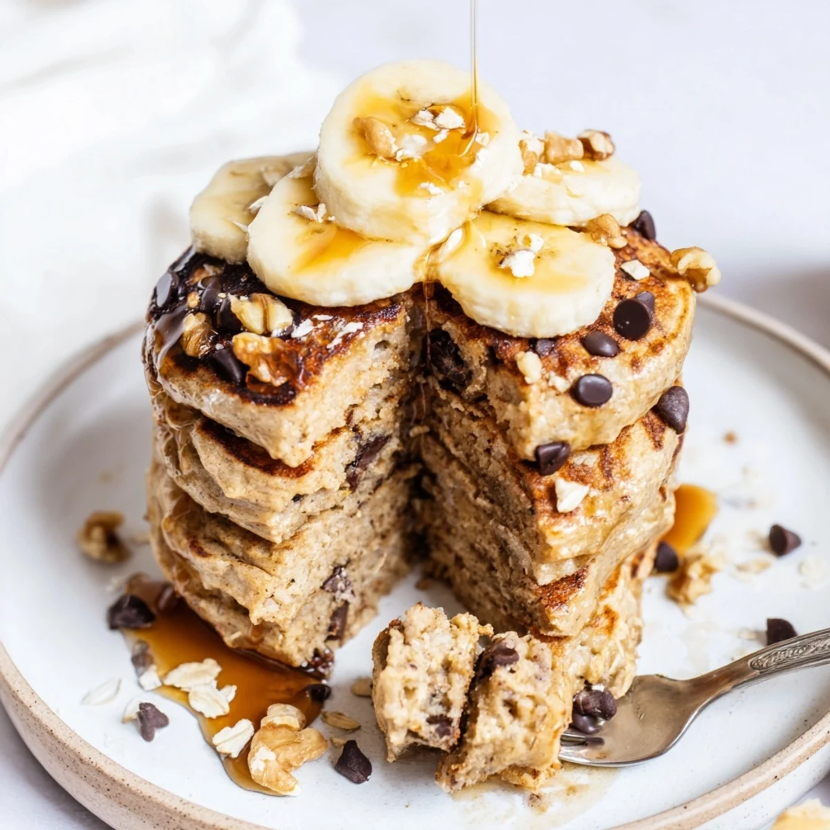 Healthy Protein Banana Pancakes topped with berries and a smear of nut butter