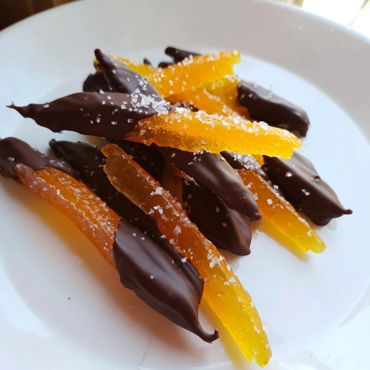Chocolate covered orange peels glistening with dark chocolate and candied citrus flavor
