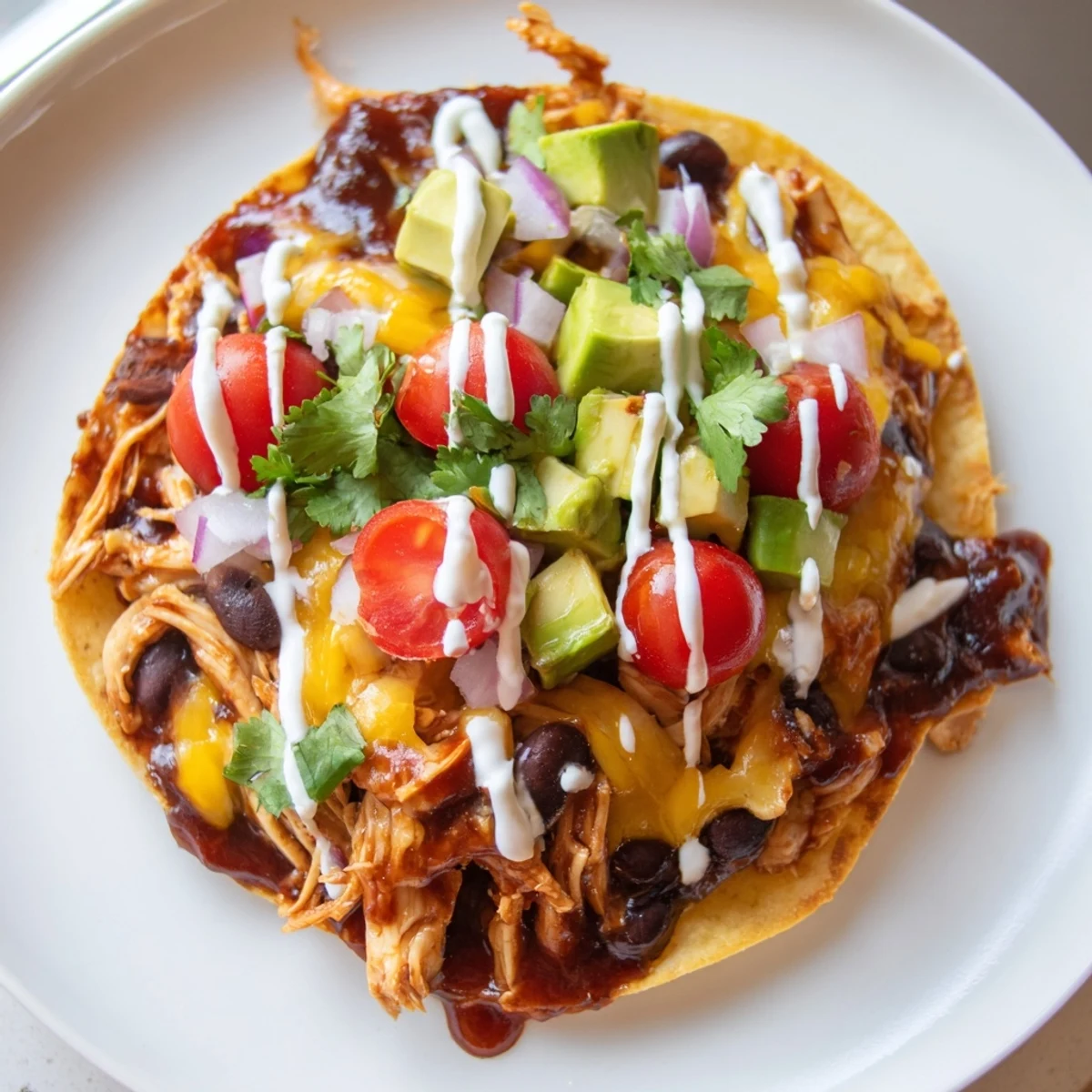 Golden tostada shells piled high with tender sweet smoky BBQ chicken and colorful veggie toppings
