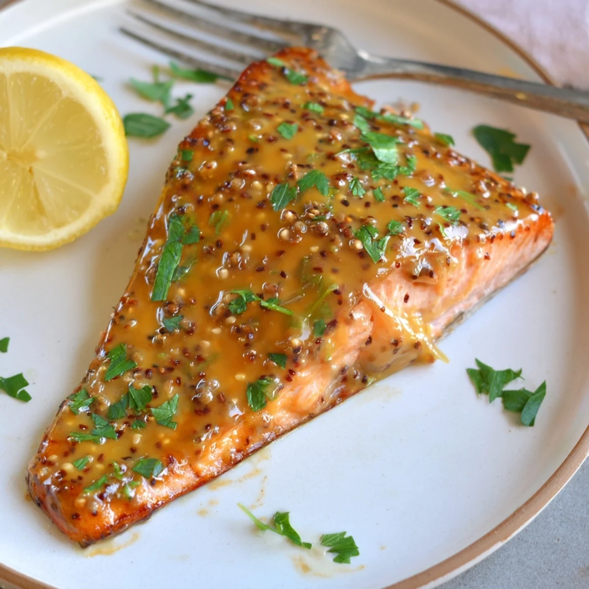 Golden baked honey mustard salmon fillets glazed and garnished with fresh parsley