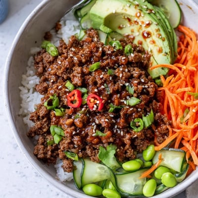 Close up of Viral Ground Beef Hot Honey Bowl with crunchy cucumber and sesame